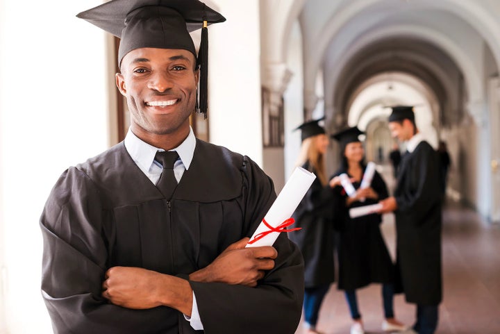 college graduate holding his diploma | Glassman Subaru in Southfield MI